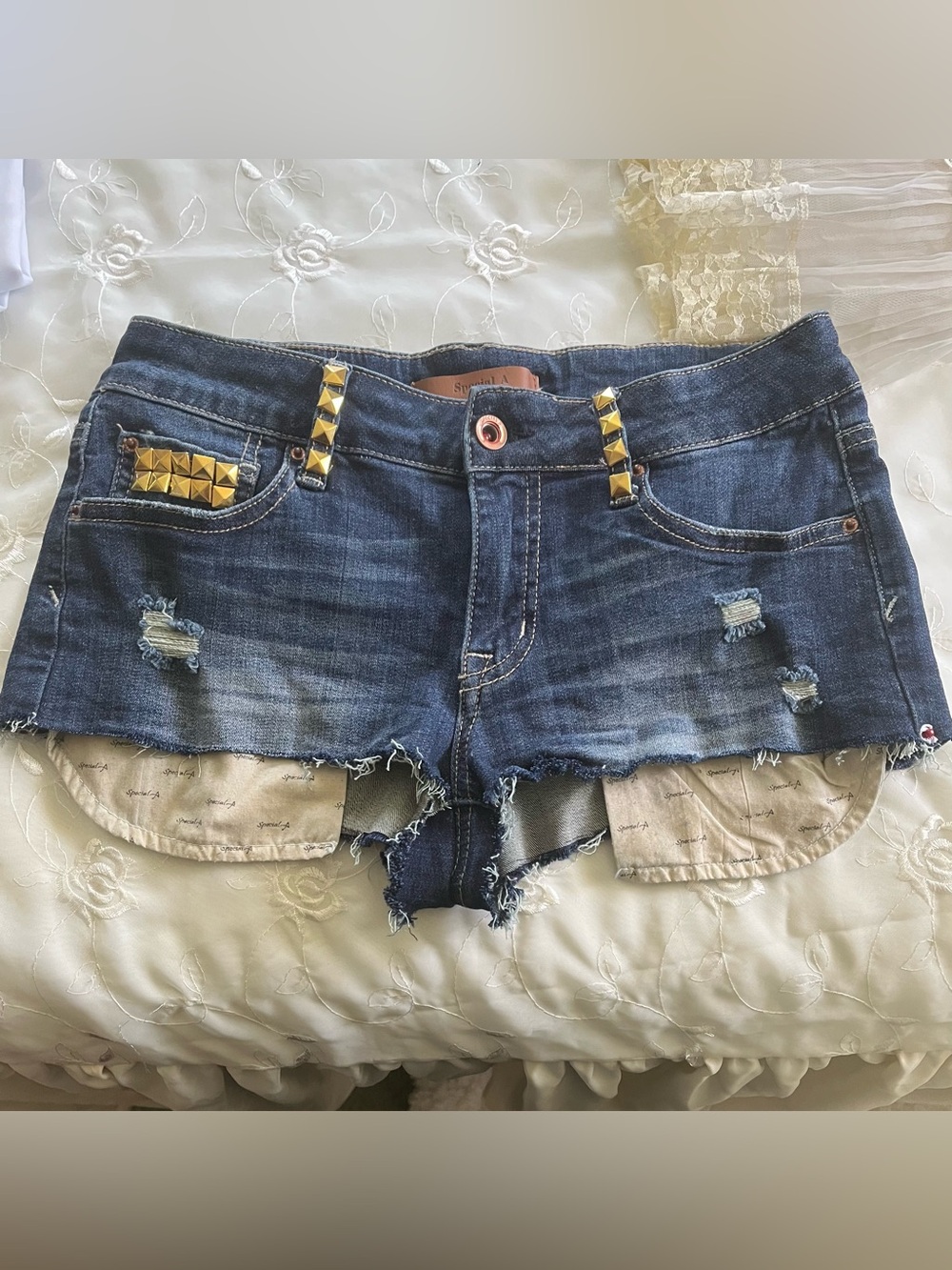Distressed Blue Denim Women's Shorts with Gold Stud Accents